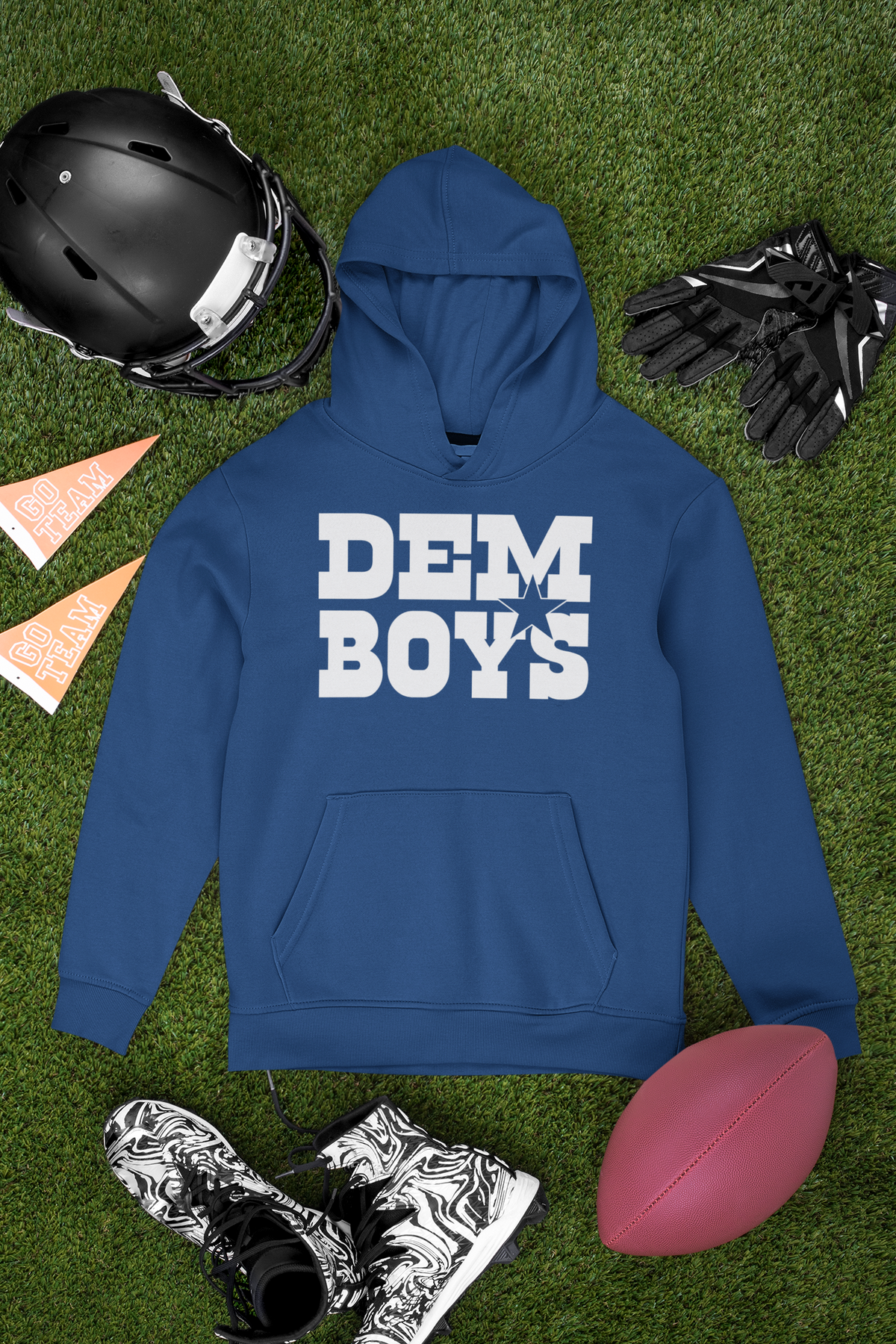 Blue Dem Boys hoodie arranged with a football, helmet and cleats on grass