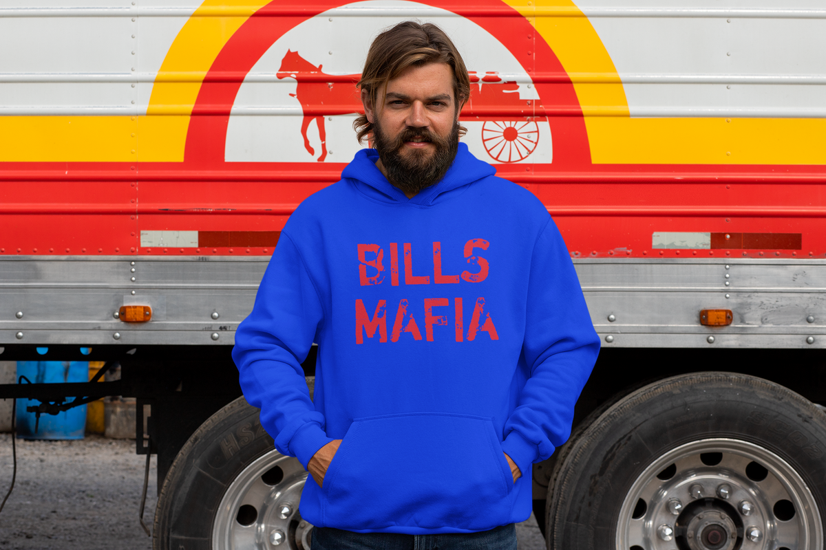 Man wearing a blue hoodie with distressed red Bills Mafia lettering beside a red truck