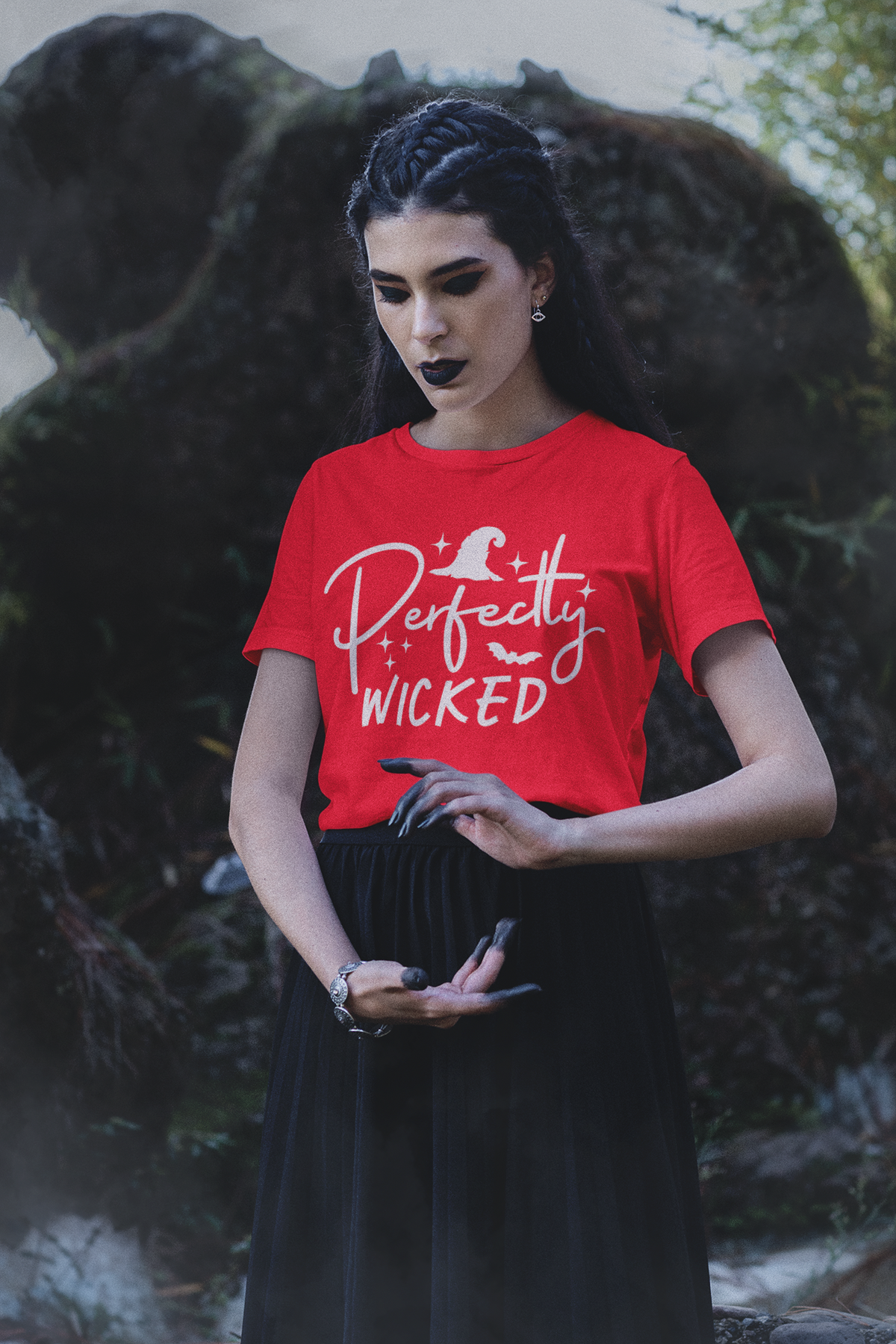 Person wearing a red Perfectly Wicked T-shirt with white witch hat lettering and bat artwork
