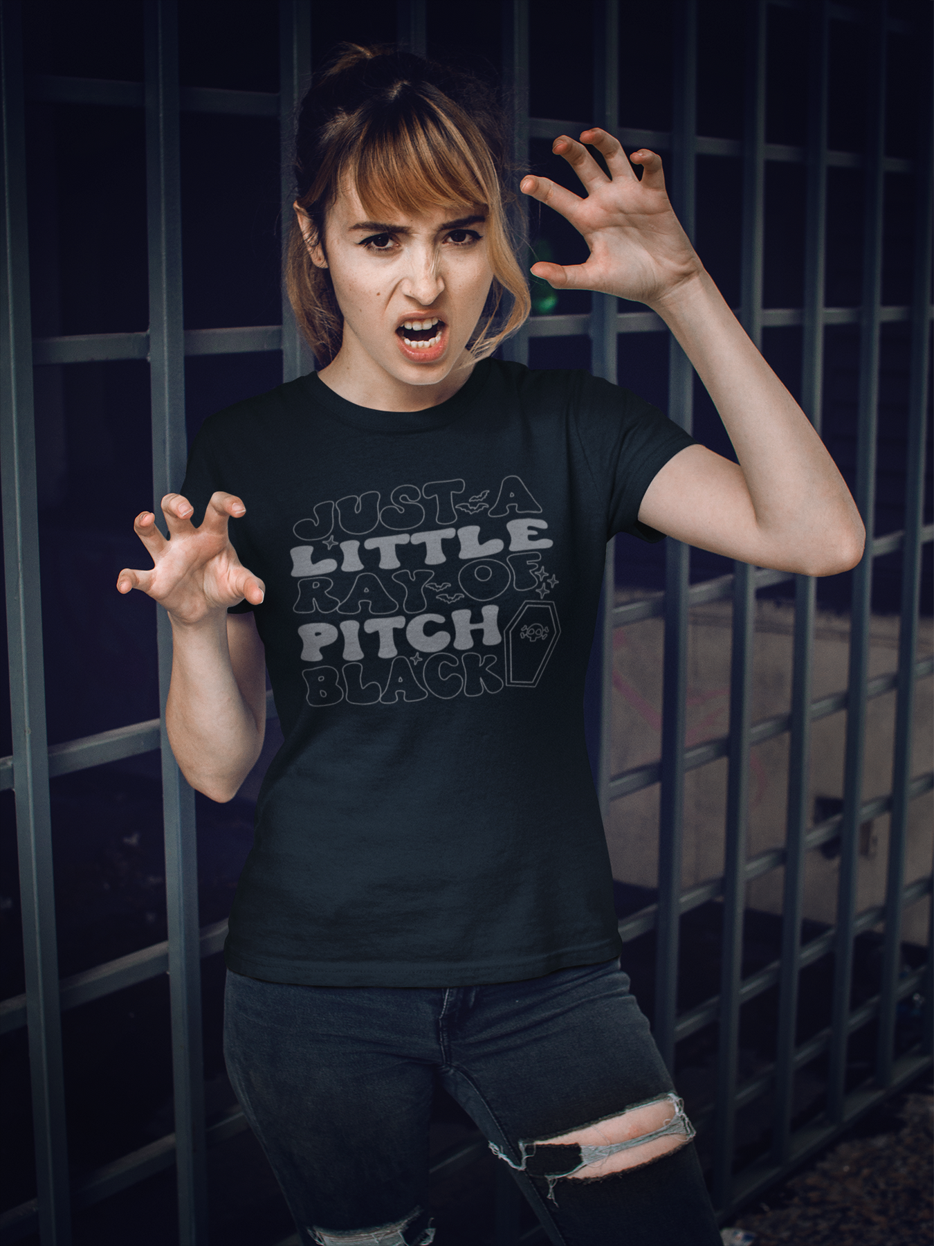 Person wearing the black Pitch Black graphic tee with grey lettering and a small coffin illustration