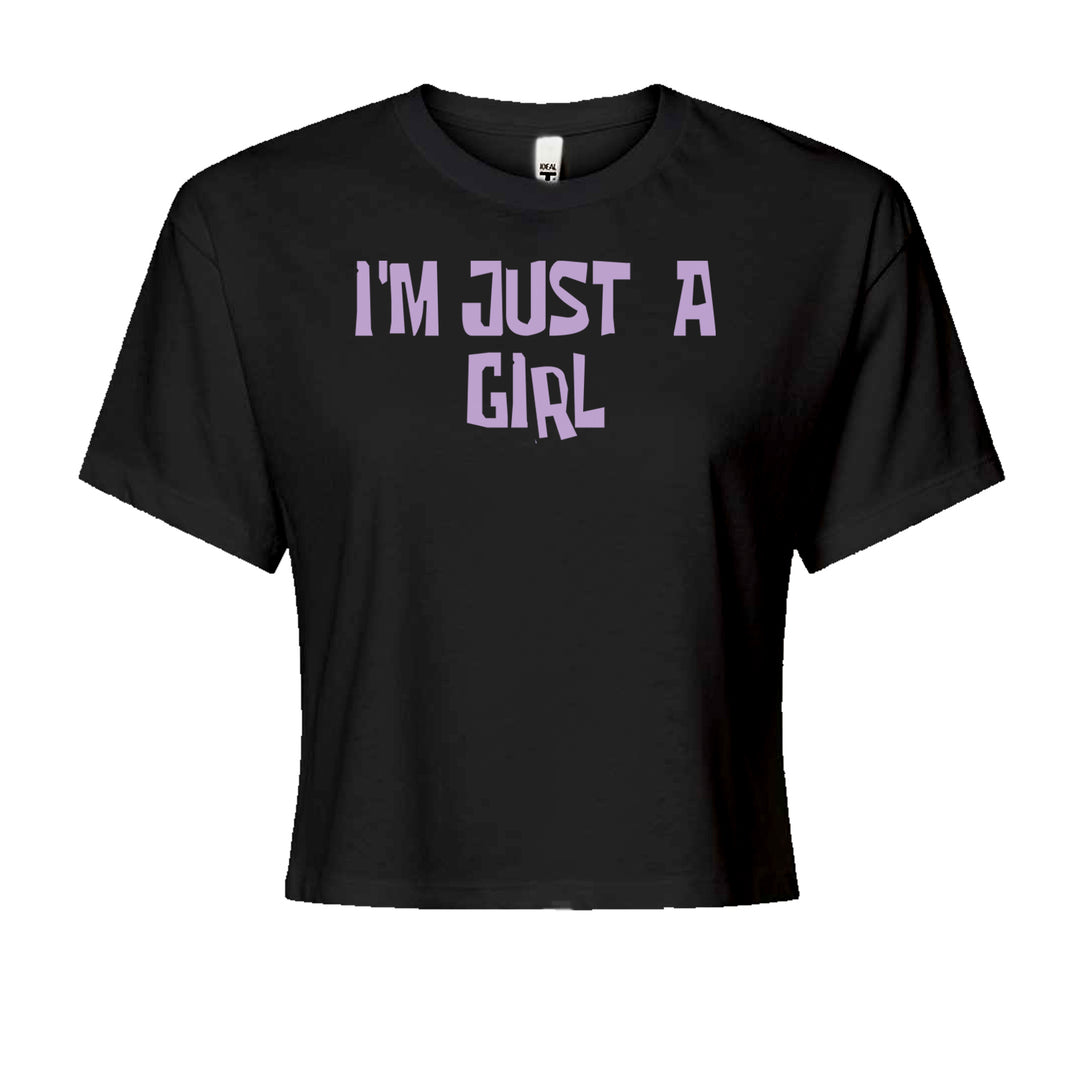 Women's boxy crop T-shirt with big lavender block text reading "I'M JUST A GIRL"