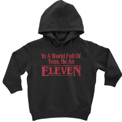 Bold "In A World Full Of Tens, Be An Eleven" text on toddler pullover fleece hoodie and infant footless fleece one-piece romper