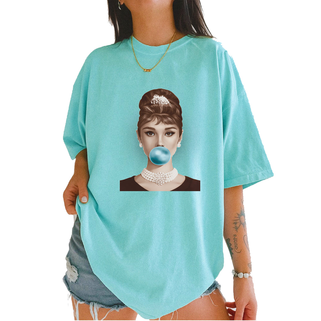 Audrey Hepburn pop-art portrait blowing a bright blue bubble gum on a Comfort Colors 1717 garment-dyed heavyweight unisex T-shirt