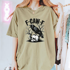Garment-Dyed Heavyweight Unisex T-Shirt featuring a crow perched on a skull with bare branches and bold gothic headline text