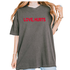 Love Hurts bold typography printed on a garment-dyed heavyweight unisex T-shirt (Comfort Colors 1717)