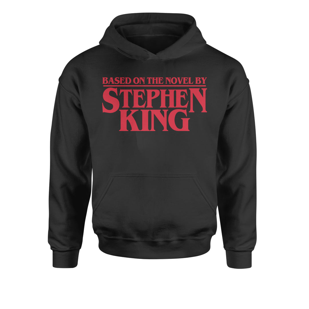 Kids' Heavyweight Fleece Pullover Hoodie with bold text reading "Based on the novel by Stephen King"